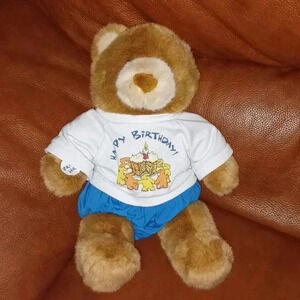 stuffed teddy  bear toy that says Happy birthday.